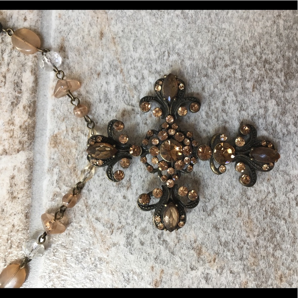Brown crystal cross necklace.